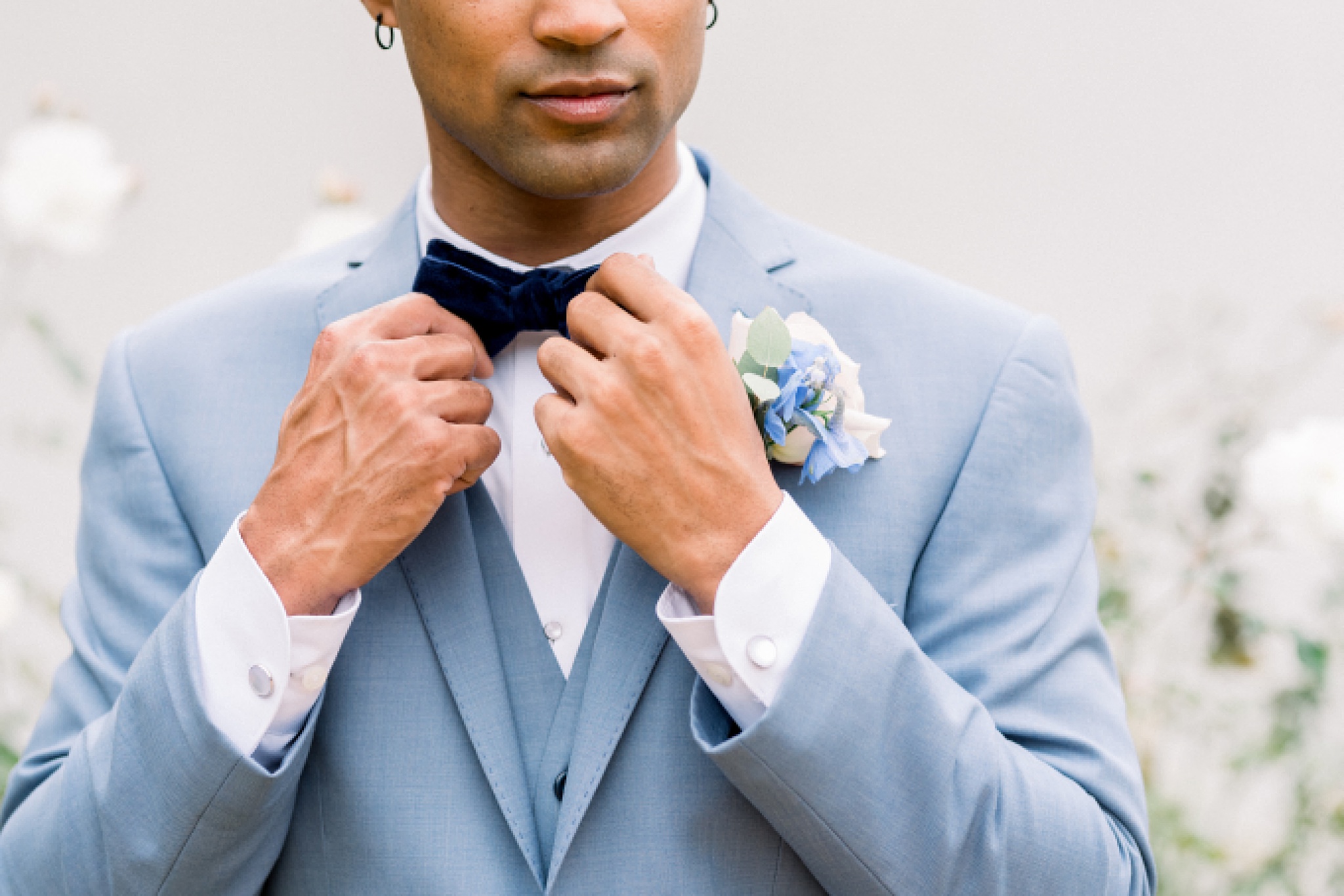Groom holding bowtie at Surf and Sand Resort Wedding