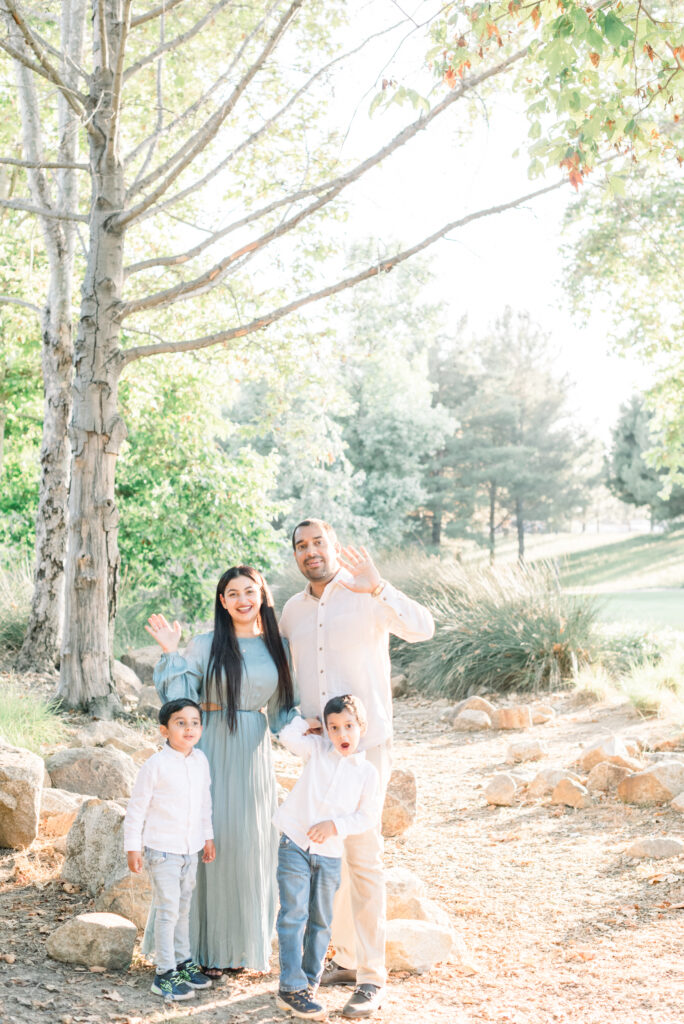 Irvine family poses and waves at the camera during a fall photoshoot with Amy Captures Love in Orange County, California