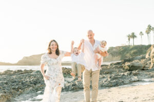Family laughs at laguna beach during their fall mini session with Amy Captures Love