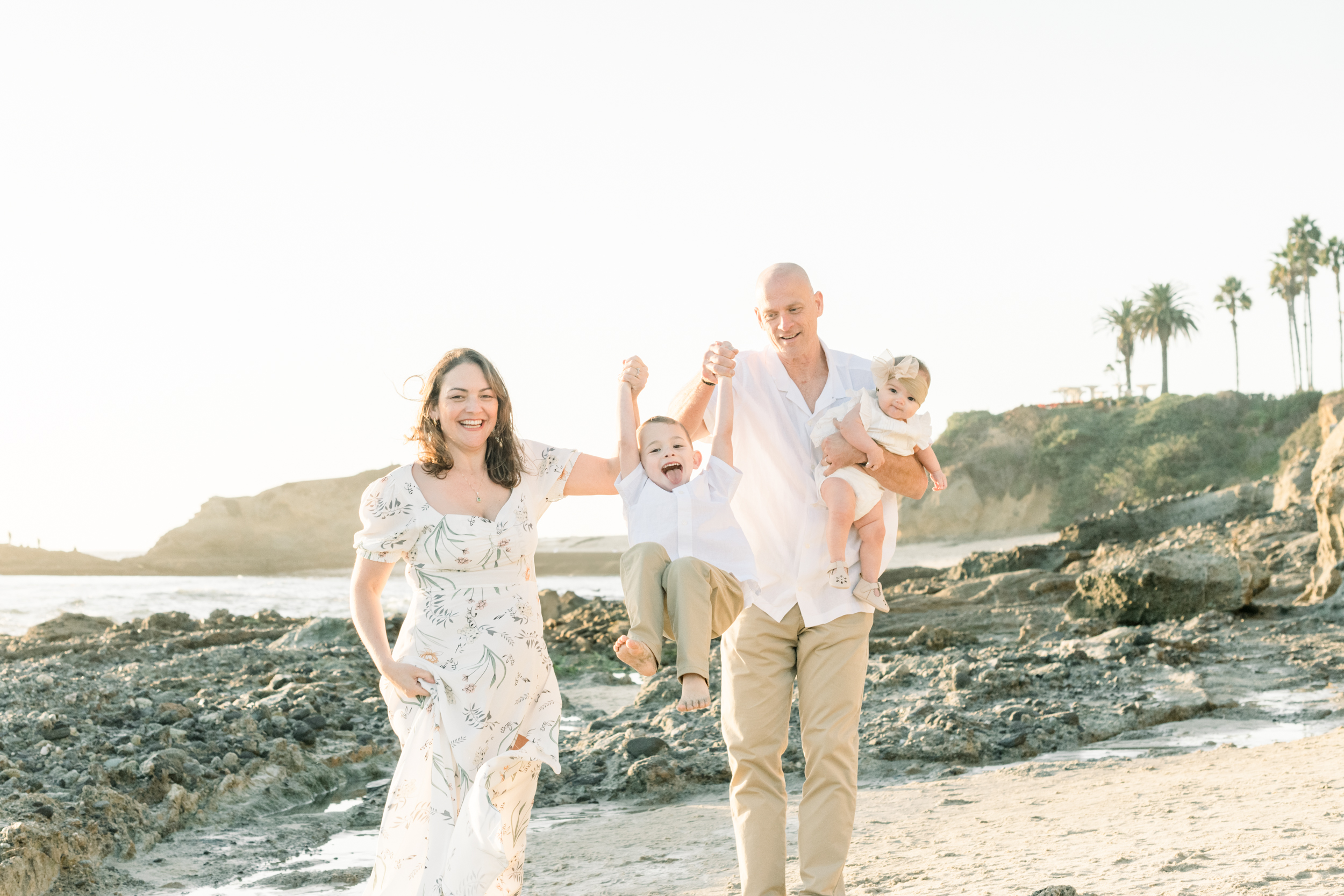 Family laughs at laguna beach during their fall mini session with Amy Captures Love