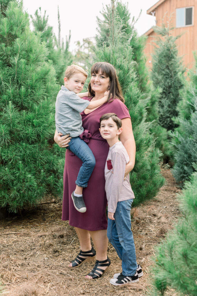 Family photographs their holiday card photos at a real tree farm in Orange County, California